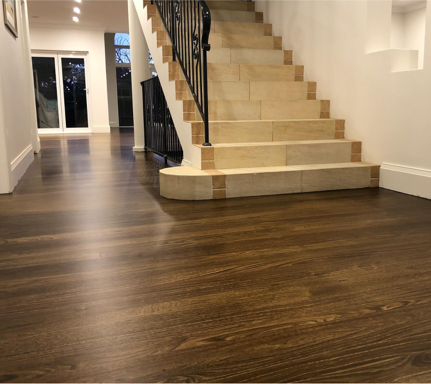 Staircase view with black railings with brand new dark wood flooring