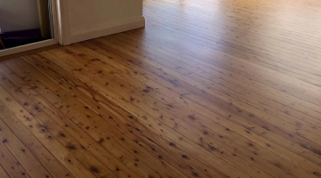 Newly furnish light wood flooring with black spots