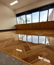 Photo of an interior with a shinny floor reflecting the window