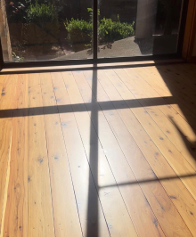 Wood flooring with the glass door outer view, shadow of the glass door pattern on the wood